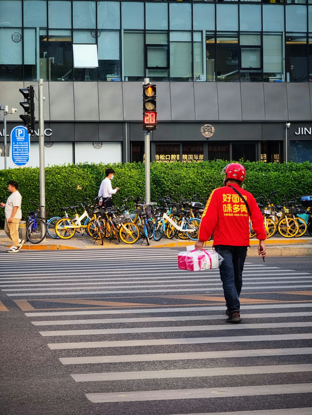 a person in a red jacket crossing the street