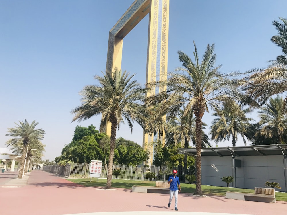 a person walking in front of a tall monument