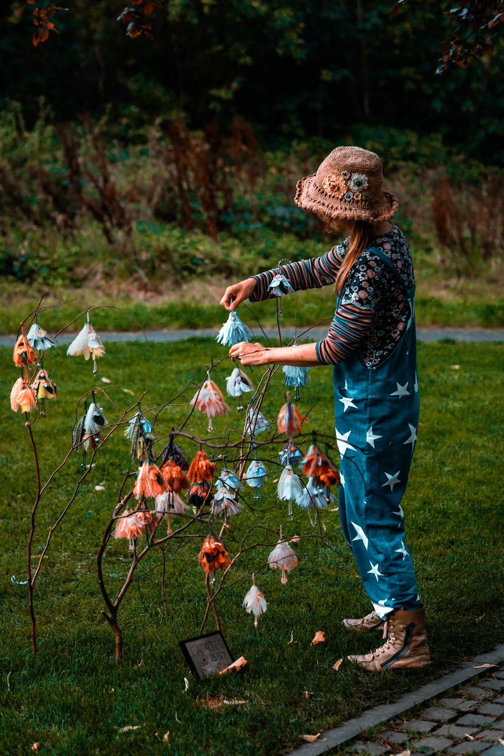 a person in a garment holding a bunch of flowers