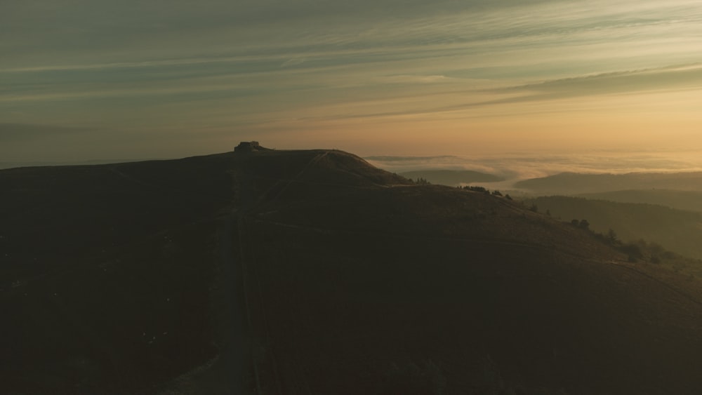 a large hill with a sunset