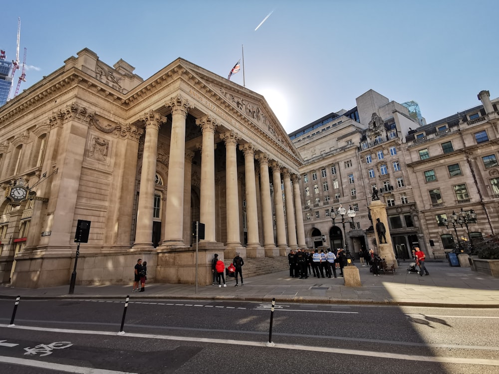 a large building with columns and a flag on top