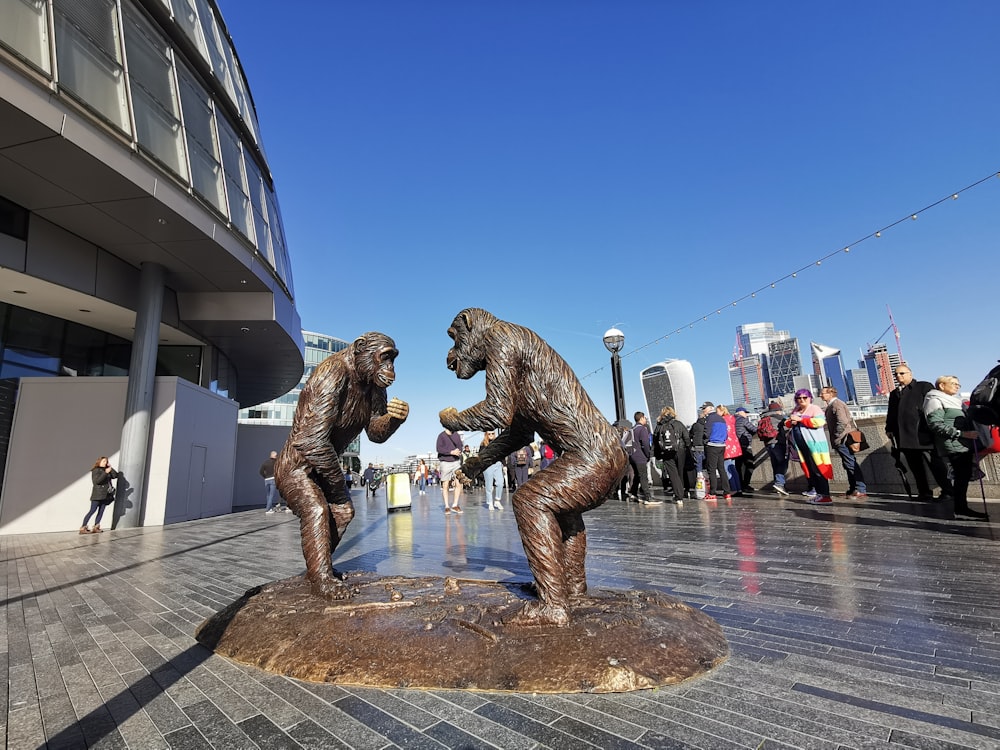 a statue of a lion and a group of people on a sidewalk