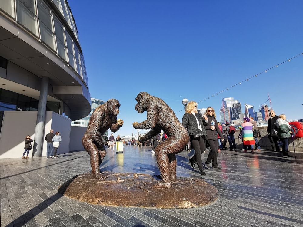 a group of people standing around a statue of a bear