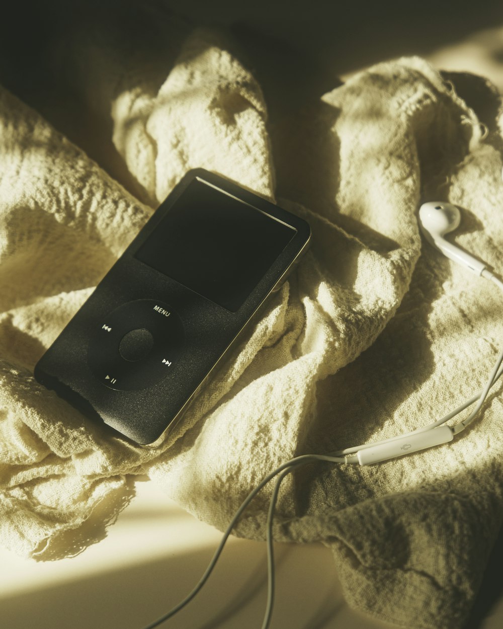 a black phone on a bed