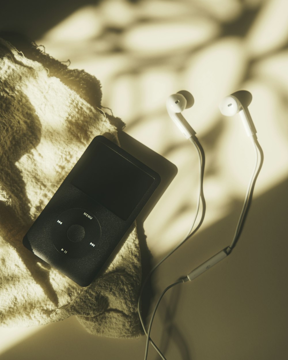 a black and white photo of a telephone on a blanket