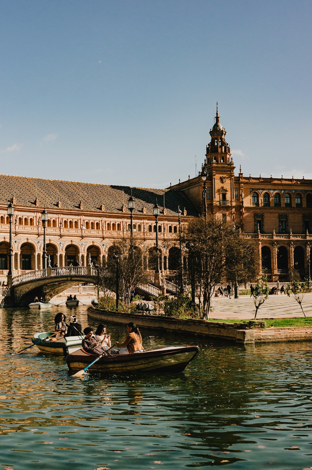 a group of people rowing boats