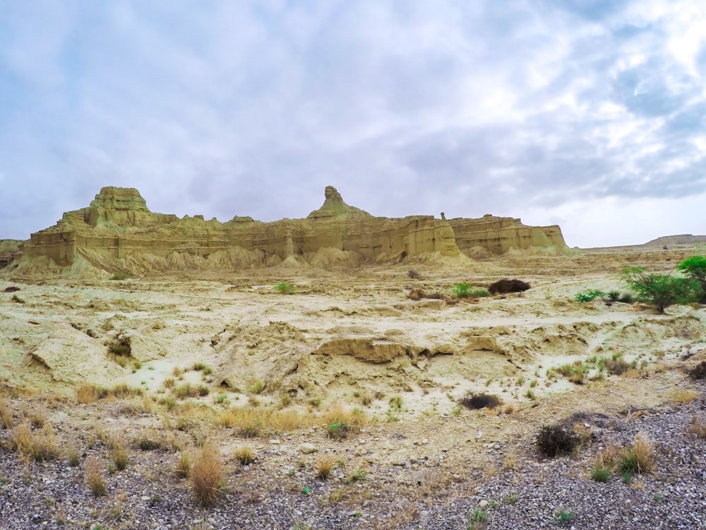 a rocky landscape with a hill in the background