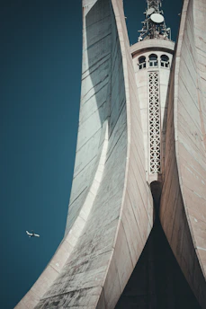 a large building towers over a city