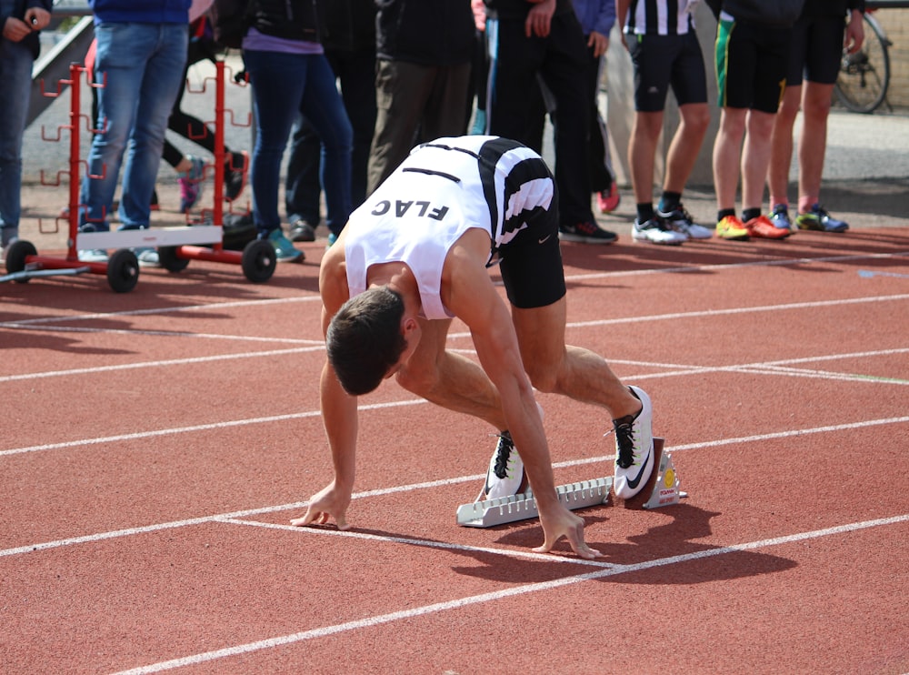 a person kneeling on a track