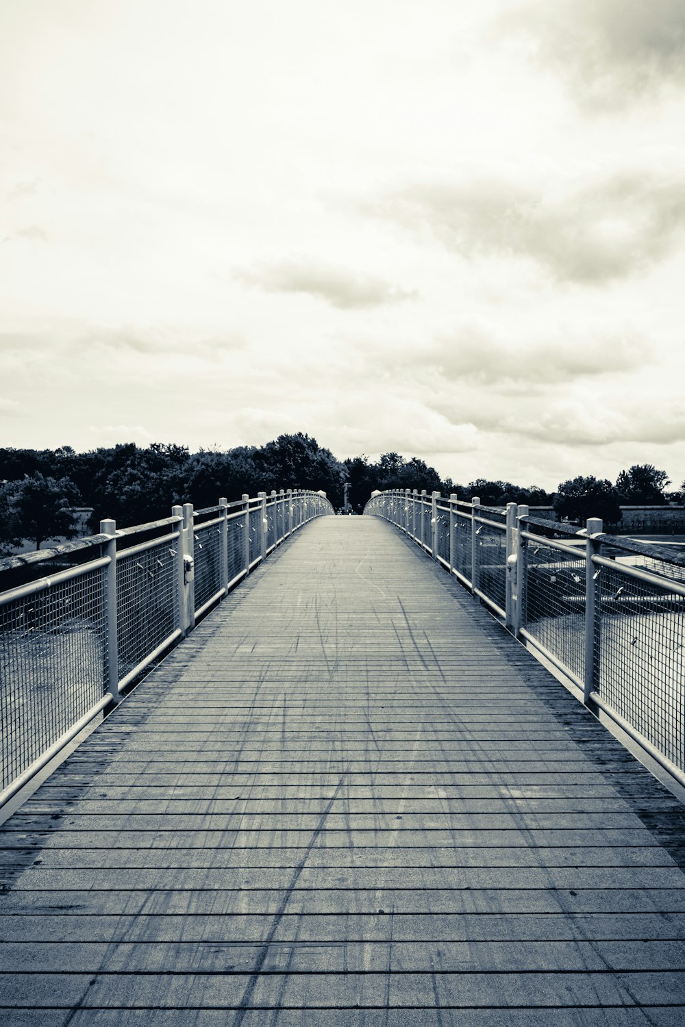 a wooden bridge with white railings