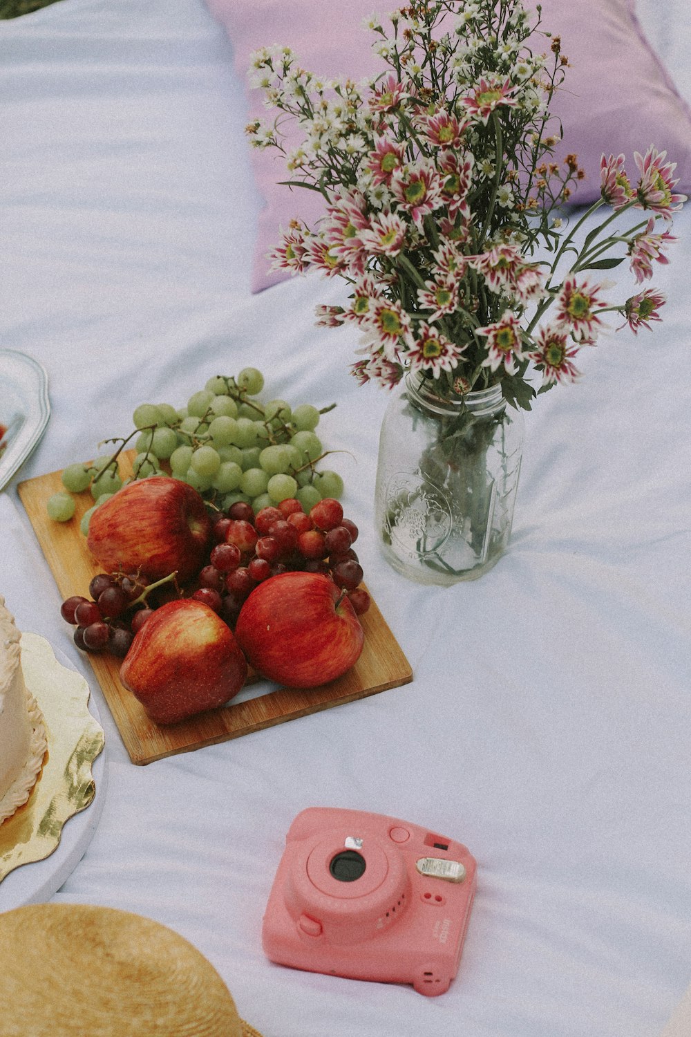 a vase of fruit and a vase of flowers