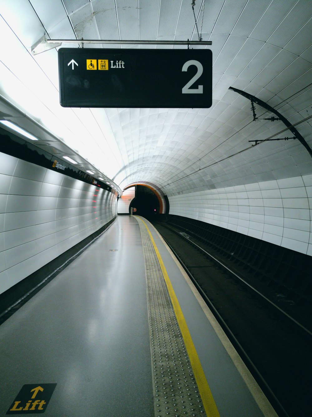 a train tunnel with a sign