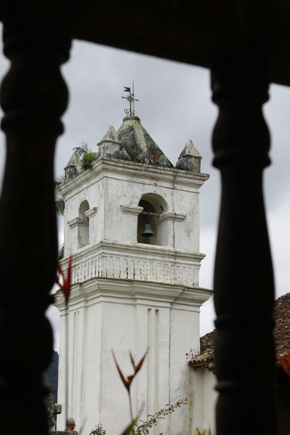 a bell tower with a cross on top