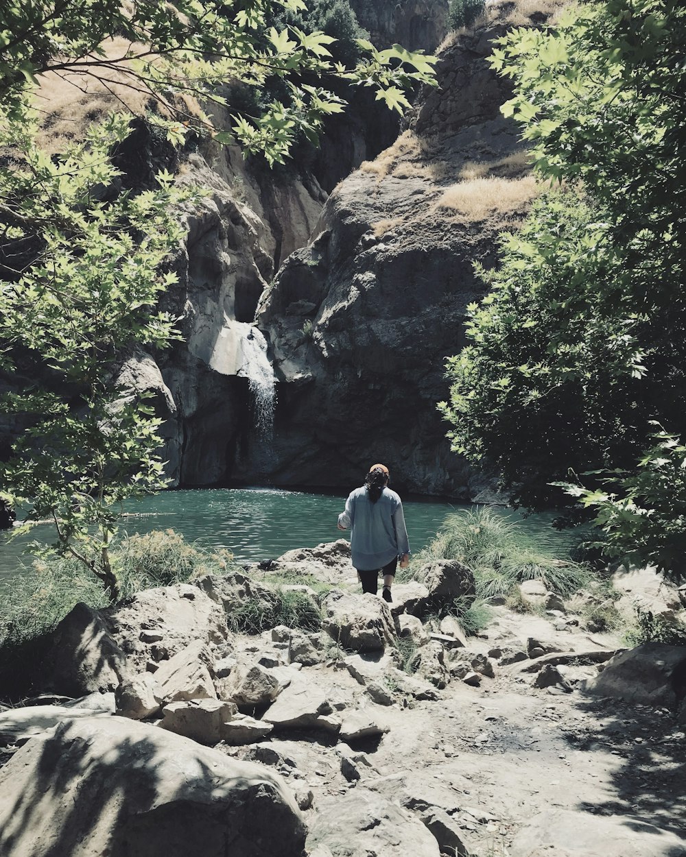 a person standing on a rocky beach