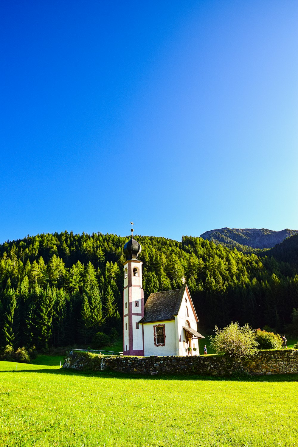 a small church in a green field