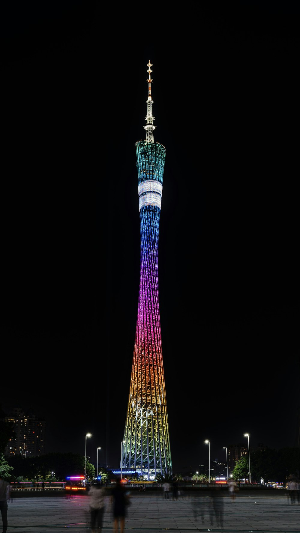a tall tower lit up at night with Tokyo Skytree in the background