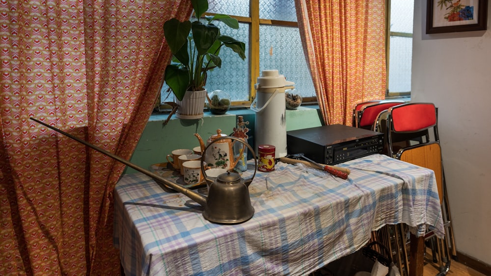 a table with a tea set and a tea kettle on it