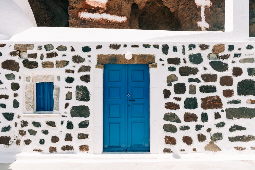 a blue door on a stone wall