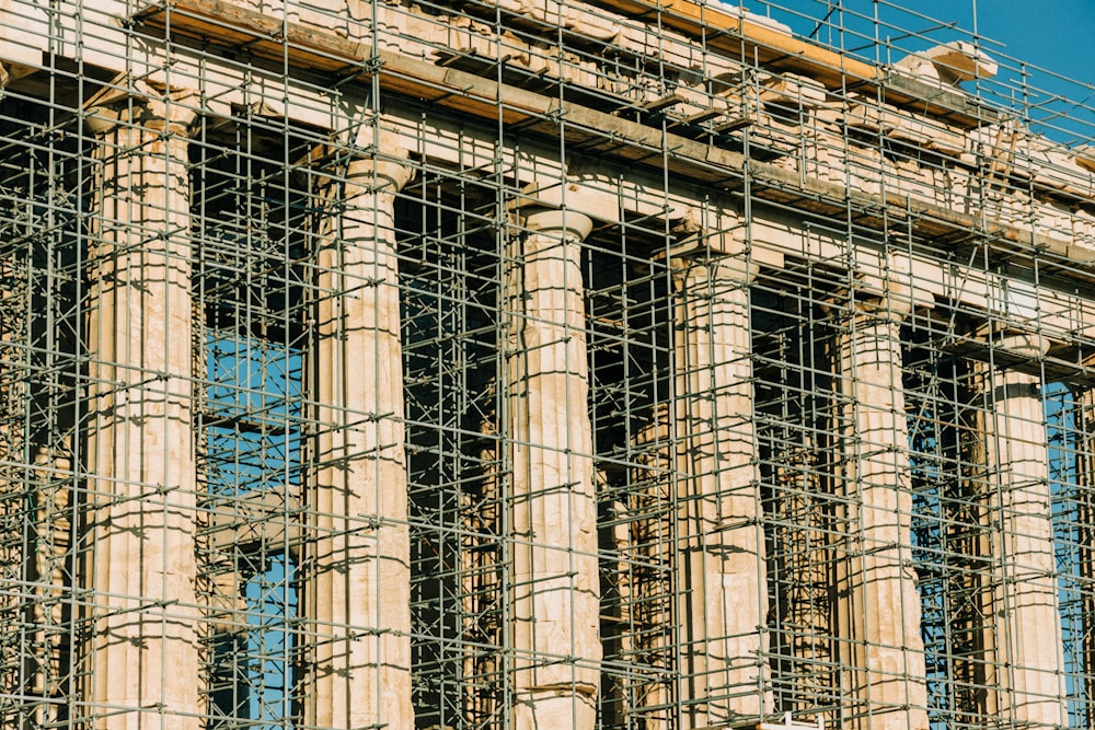 a fenced off area with a building behind it