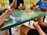 A group of enthusiastic players gathered around a table playing trading card games.
