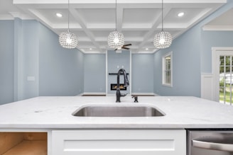 a kitchen with a sink and a chandelier