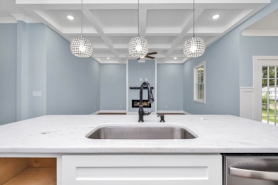 a kitchen with a sink and a chandelier