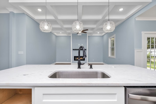 a kitchen with a sink and a chandelier