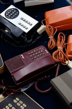 a red telephone on a desk