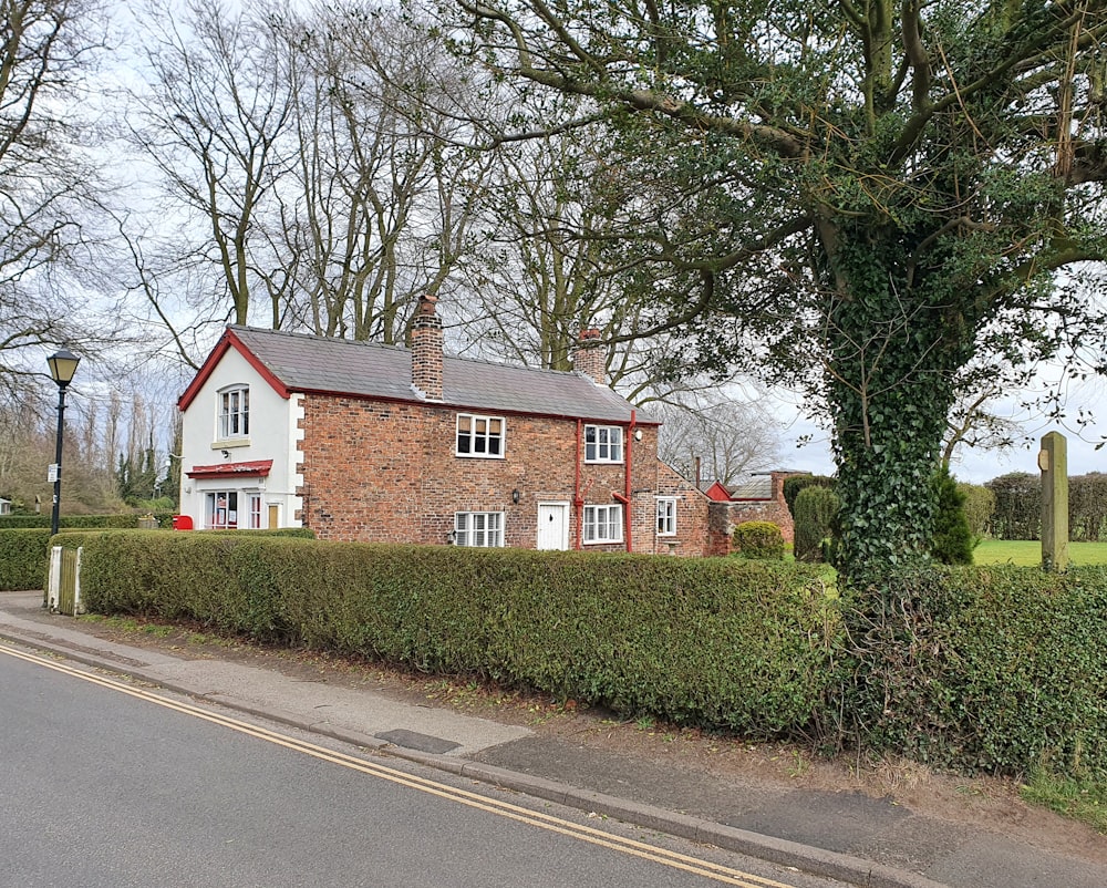 a house with a hedge in front of it