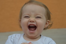 A candid moment of a child laughing with a warm, light background