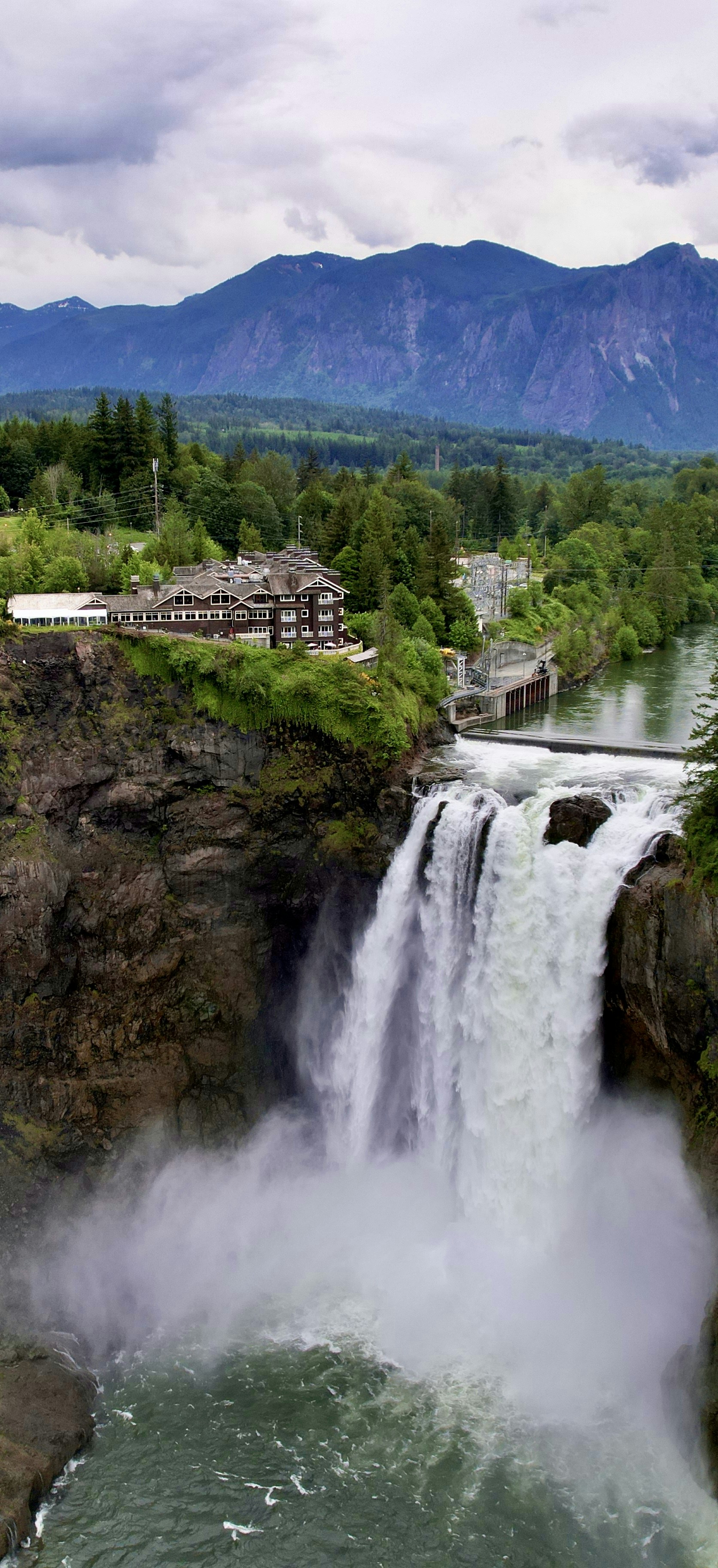 a waterfall with a building in the background