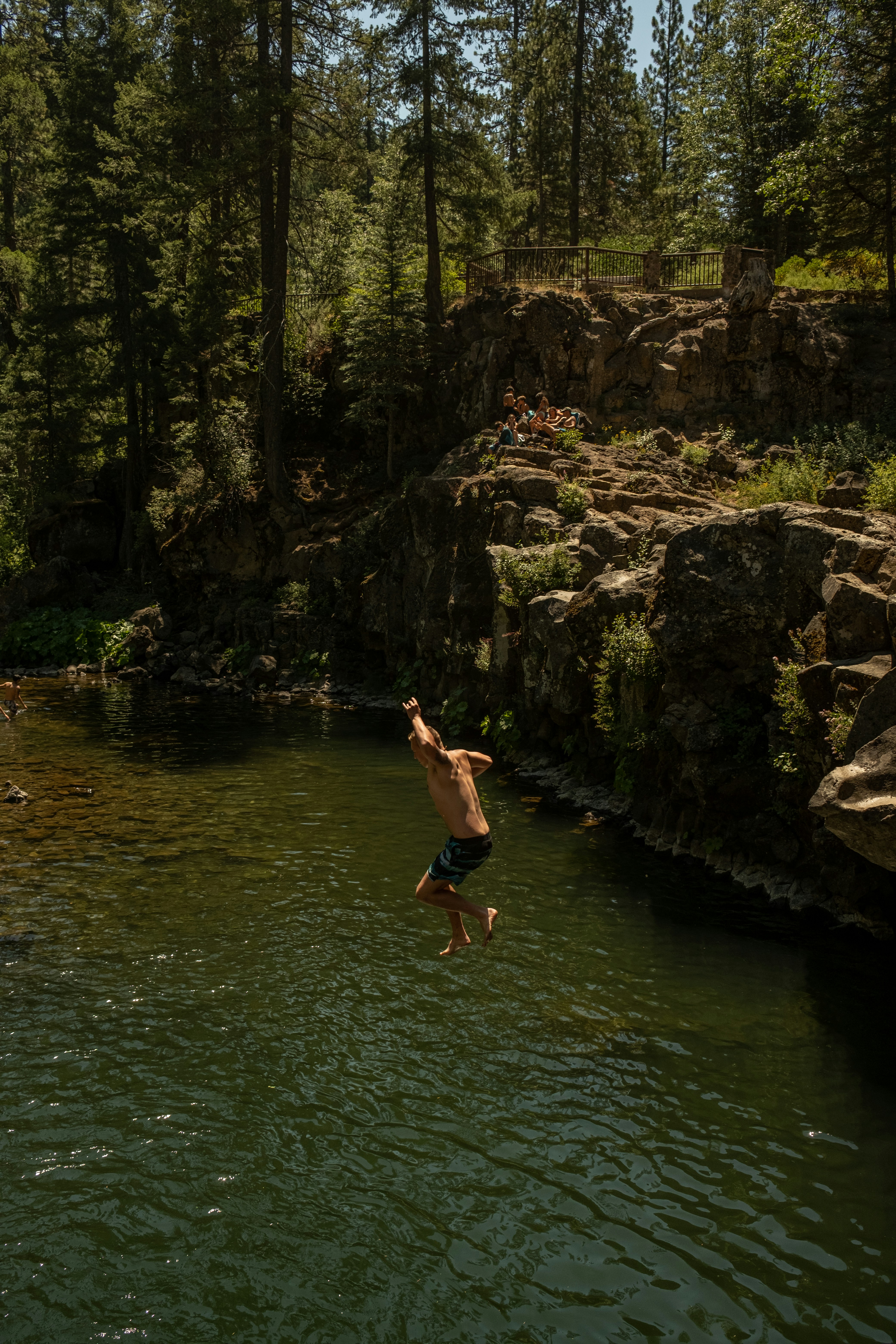 a man jumping into a river
