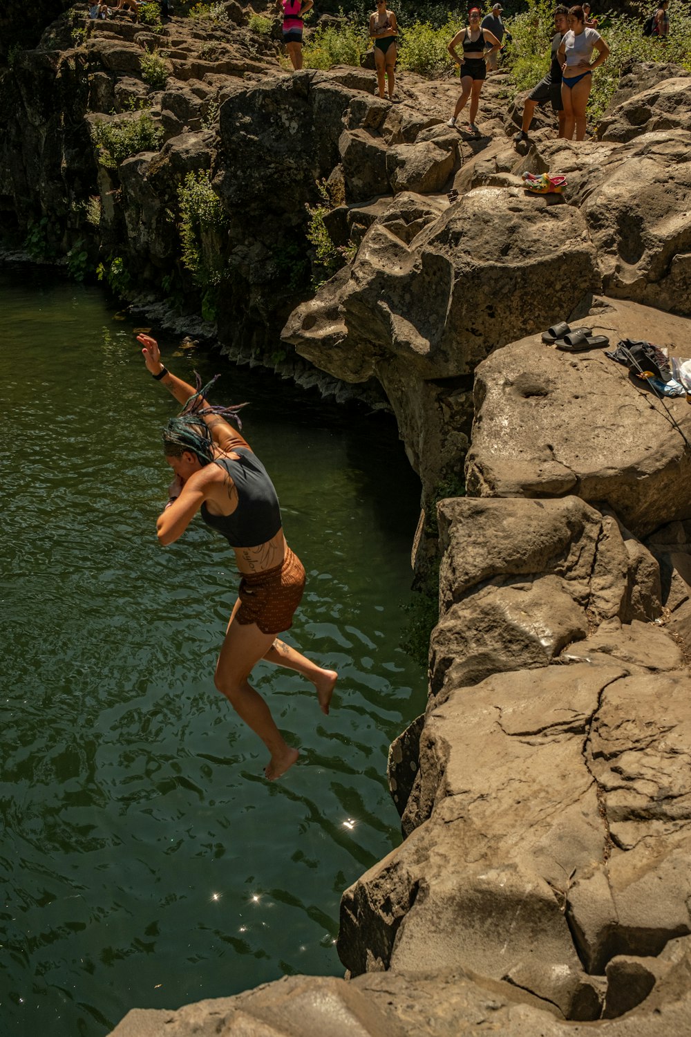 a man jumping into a pool of water