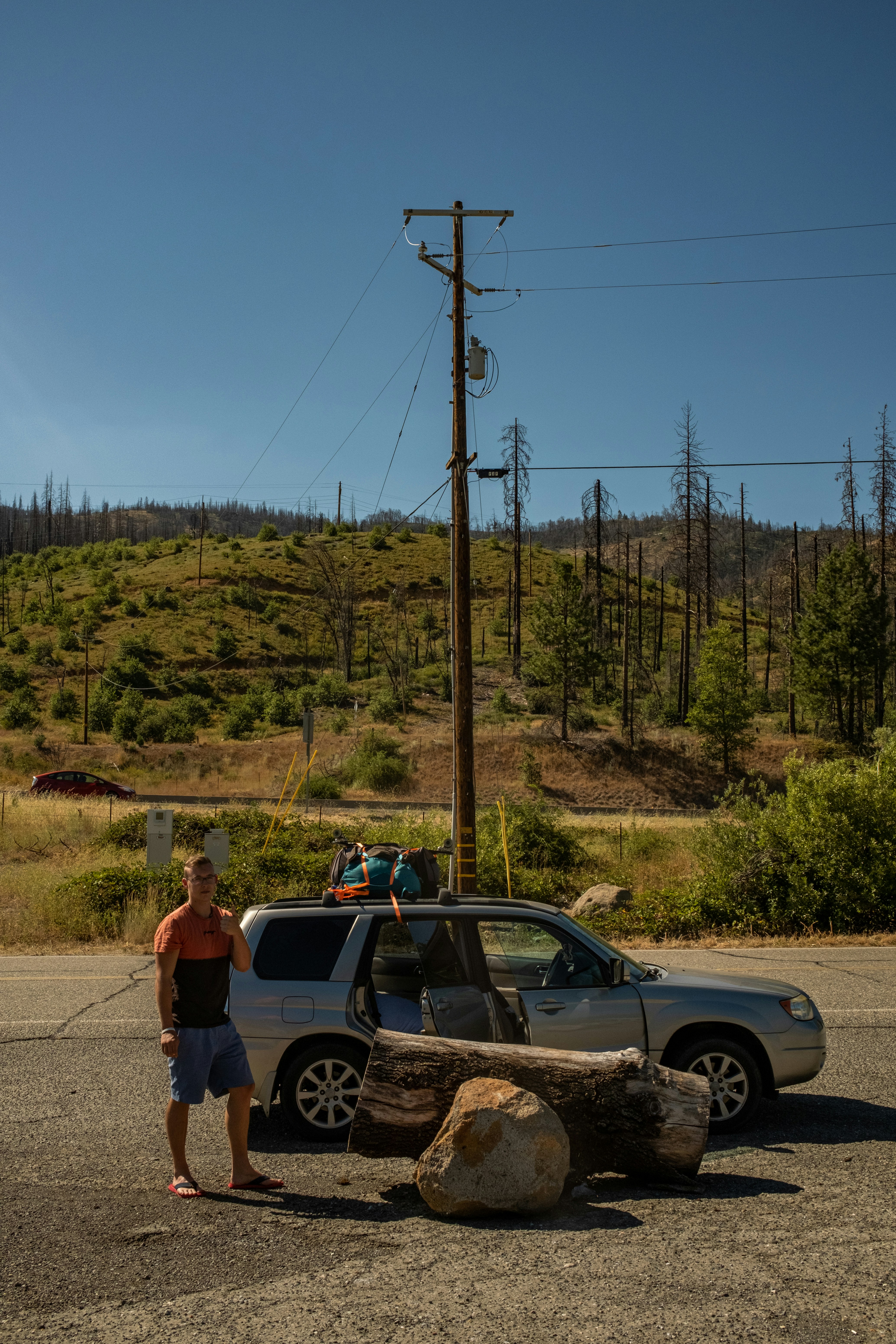 a person standing next to a car
