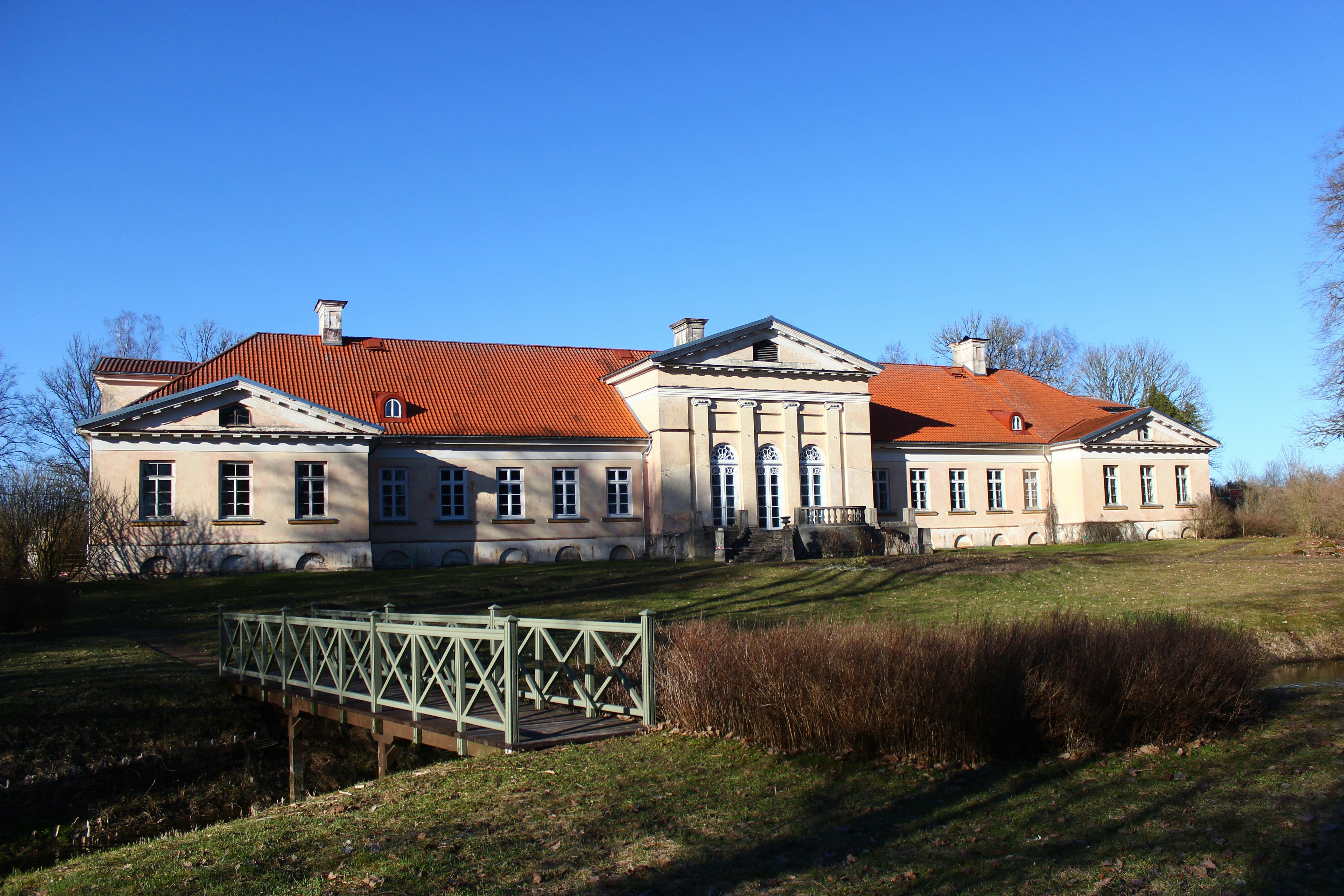 a large house with a fence in front of it