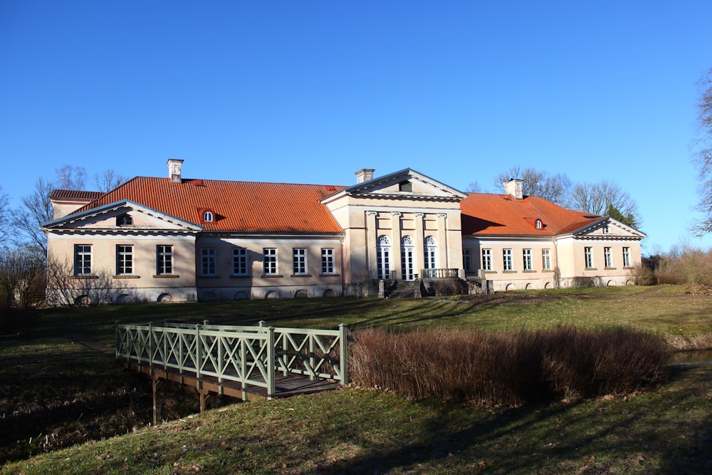 a large house with a fence in front of it