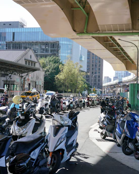 a large group of motorcycles parked under a bridge