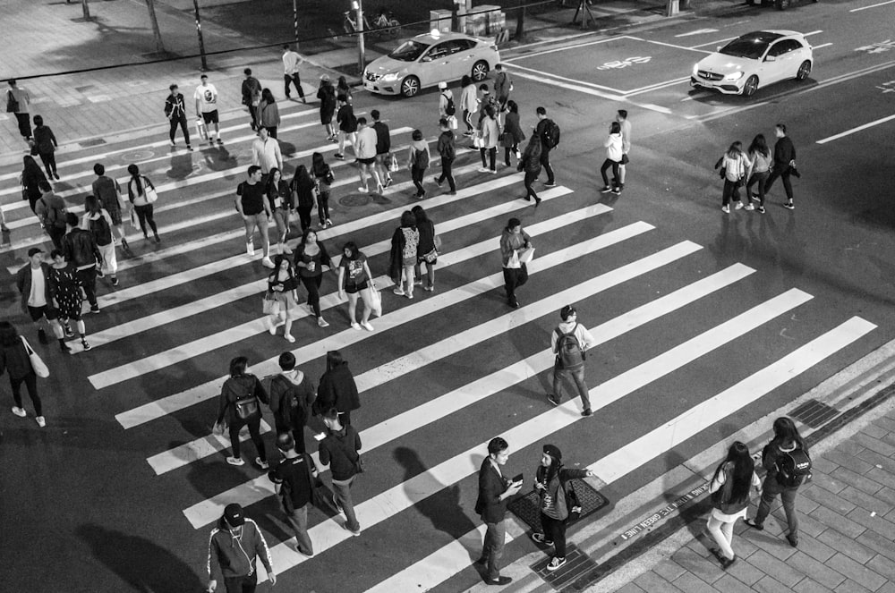 a group of people crossing a street