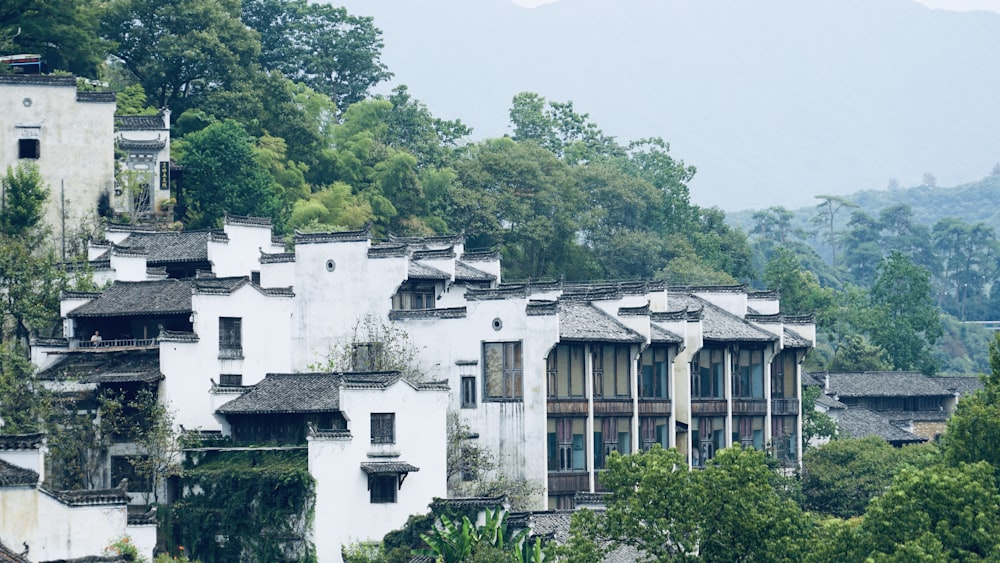 a group of buildings with trees in the back