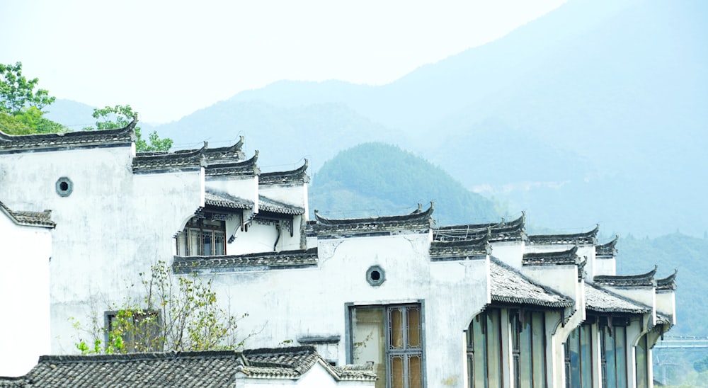 a white building with a mountain in the background