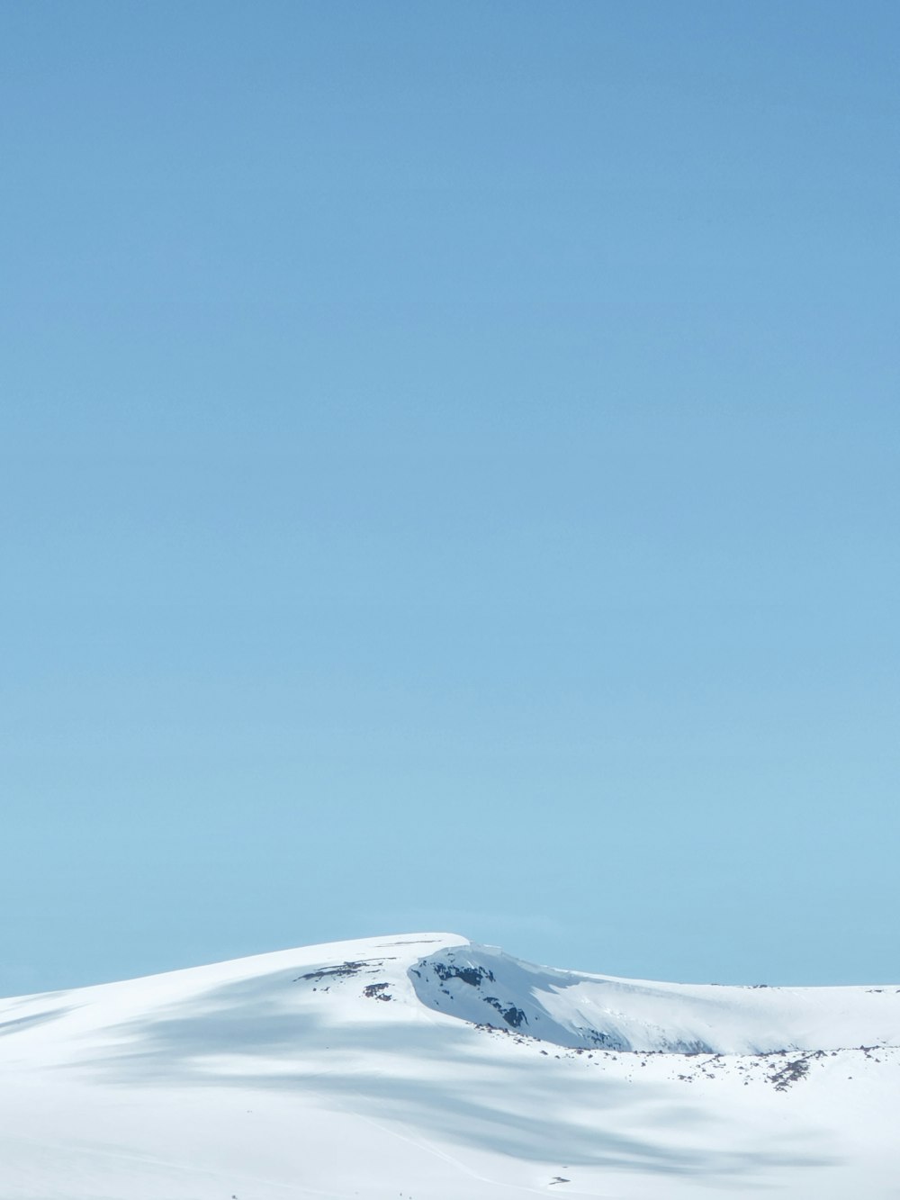 a snowy landscape with a blue sky