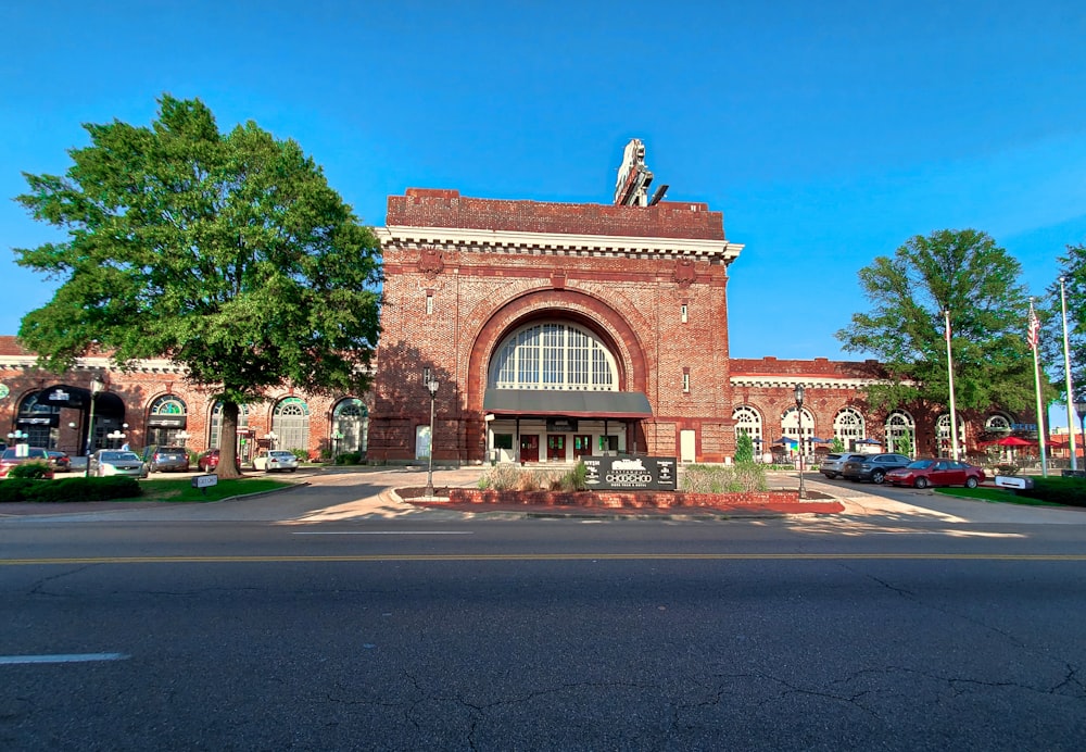 a large brick building with a statue on top