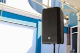 a black speaker on a pole