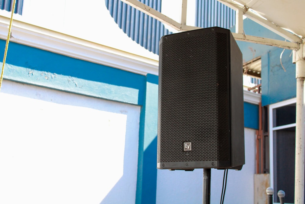 a black speaker on a pole