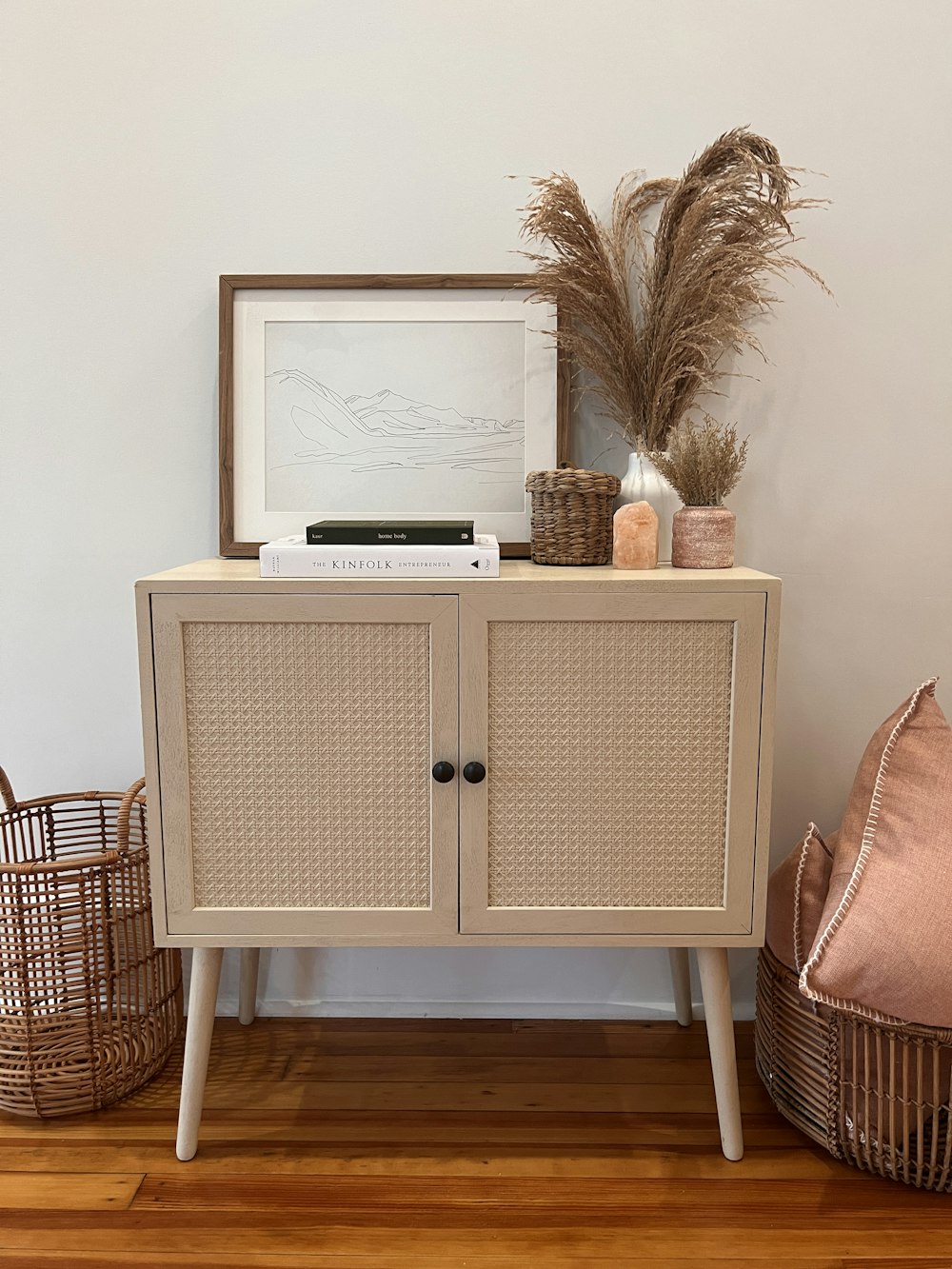 a white cabinet with a picture on top