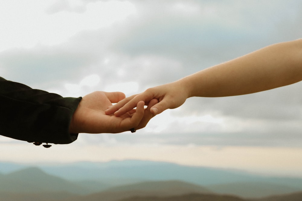 a close-up of hands shaking