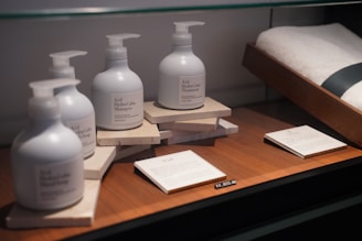 a group of white bottles on a wooden table