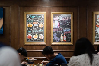 A cozy restaurant table with a QR code menu on display and customers happily ordering.