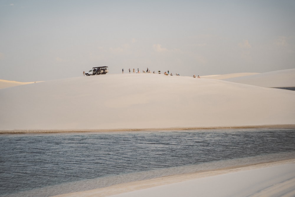 a group of people walking on a beach