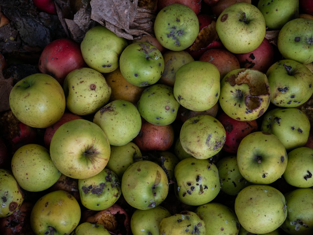 a pile of green and red fruit